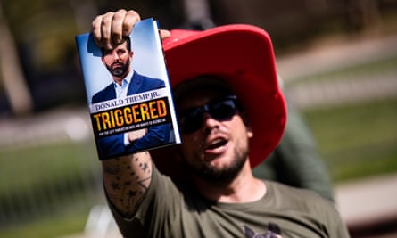 A Trump supporter holds a copy of Donald Trump Jr.’s book amid protests and counter-protests at the event on the UCLA campus.
