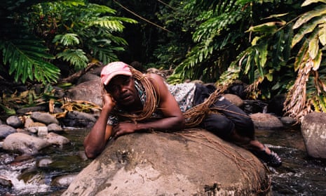 Moïse Polobi of Polobi & the Gwo Ka Masters reclining on a rock.