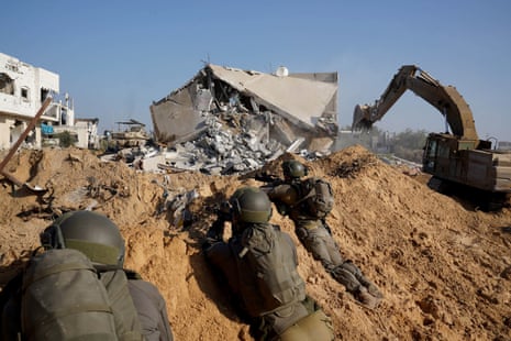 This handout picture released by the Israeli army on 3 January 2024 appears to show Israeli forces using excavation equipment inside the Gaza Strip at an undisclosed location.