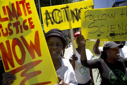 Demonstrators hold up placards during a climate protest in Johannesburg in 2019