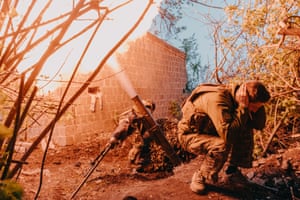 Soldiers fire a mortar round