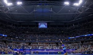 Novak Djokovic serves in majestic Arthur Ashe Stadium.