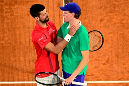 Novak Djokovic congratulates Jannik Sinner at the net after their French Open semi-final.