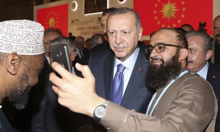 Turkish President Recep Tayyip Erdogan poses for a selife during an African Muslim Religious Leaders Summit