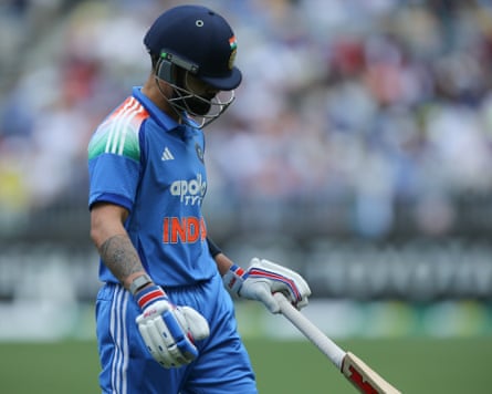 Virat Kohli walks off after being dismissed for a duck by Mitchell Starc.