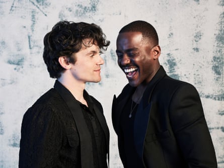 Edward Bluemel and Ncuti Gatwa dressed in Black facing one another