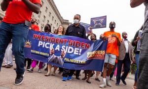 Jesse Jackson helps carry the banner during the Black Voters Matter March, earlier this month. The 79-year-old is currently in hospital receiving treatment for Covid-19.