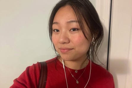 selfie of person wearing red shirt and white earphones