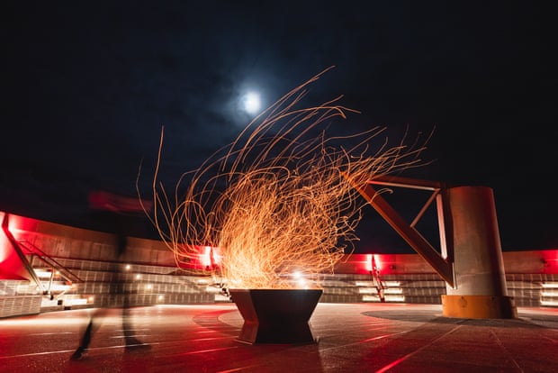 A small amphitheater illuminated with red and orange lights