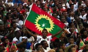 A man holds an Oromo Liberation Front flag as people in Addis Ababa celebrate the triumphant return of Oromo activist Jawar Mohammed