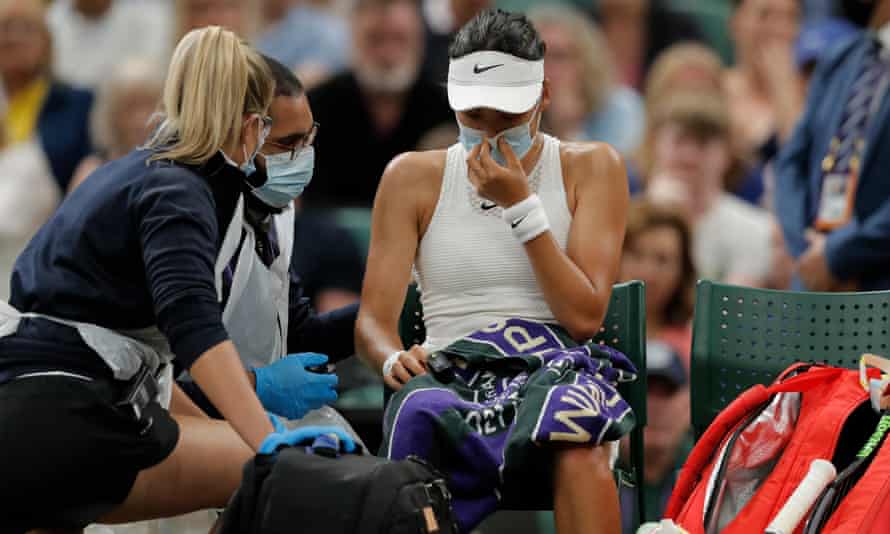 Raducanu is checked by a doctor before going off court and retiring from her fourth-round match with Alja Tomljanovic at Wimbledon.