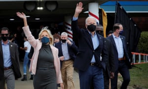 Former Vice President Joe Biden and his wife Jill wave to supporters as they walk to an Amtrak train to begin a campaign train tour in Cleveland, Ohio.