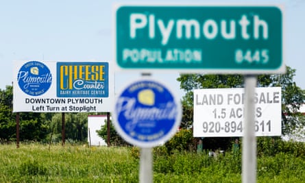 Road signs posted on Highway 57 at the entrance to the town of Plymouth, Wisconsin.