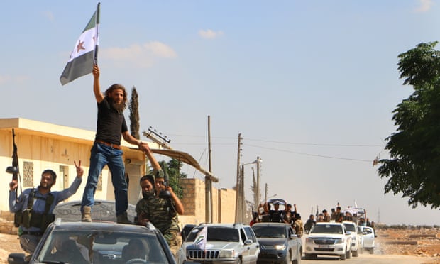 Syrian rebel fighters from the recently formed National Liberation Front parade in Idlib province.