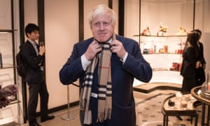 Back in 2015... Boris Johnson (then Mayor of London) tried on a Burberry scarf, during the opening night of the clothing designers new shop in Tokyo.