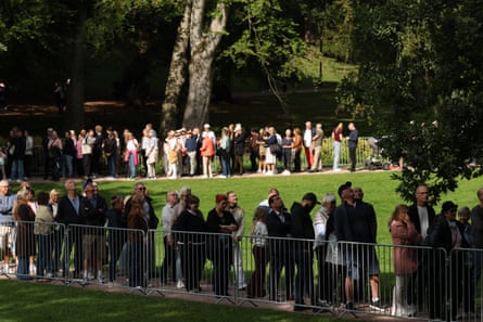 People line up in a park to pay their respects to the late King Harald V.