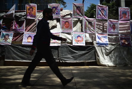 A man walks in front of the memorial site for the 43 missing students from the Ayotzinapa normal school in Mexico City, on 23 August 2022.