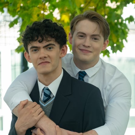 The two leads from Heartstopper, one with arms around the other