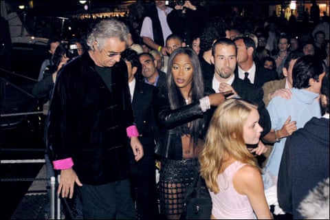 Virginia Roberts Giuffre in the foreground wearing a pale-pink sleeveless top in a crowd of people including Naomi Campbell and her then partner Flavio Briatore