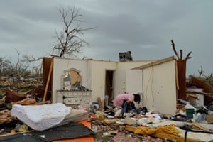 Becky Myles searches for belongings in the wreckage of her home after thunderstorms spawning high straight-line winds and tornadoes ripped across the state in Rolling Fork, Mississippi, US