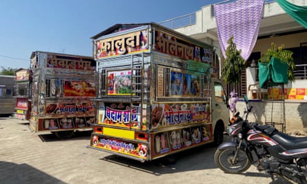 Three brightly painted trucks, decorated with pictures of ice-cream and mythological figures