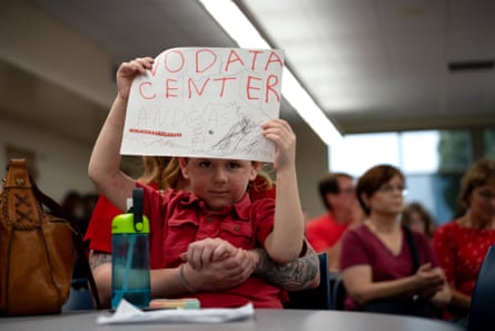 a young boy holding a sign
