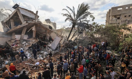 palestinians standing by rubble of a house in gaza