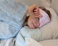 The writer lies in bed wearing the Snoozeband silk