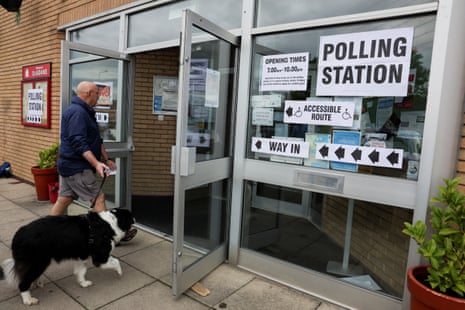 A man, with his dog, arrives to vote in the Makerfield by-election, triggered by the resignation of Labour MP John Simons, at St. Aidan’s Parish Centre, in Winstanley, Wigan, Britain, June 18, 2026.