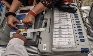 An Indian election worker learns how to operate a voting machine.