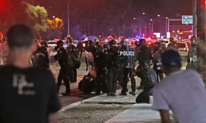 Police in riot gear move in to break up a group of marchers in Phoenix.