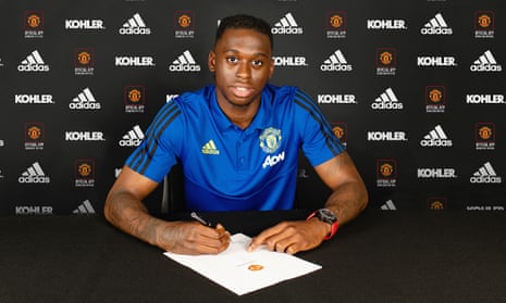 Aaron Wan-Bissaka poses after signing for Manchester United.