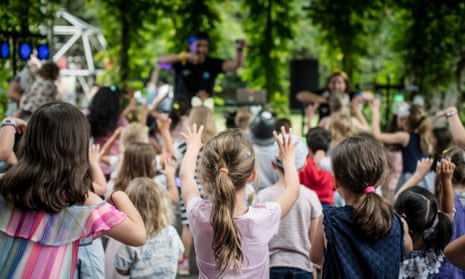 Children watch performers at the NGV's summer festival for kids