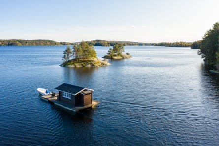 A floating houseboat on a large lake dotted with tiny islets.