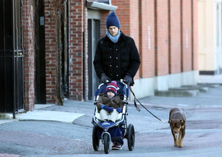 Tom Brady walks with his son and dog, Lua, along the Charles River in Boston in December 2012.