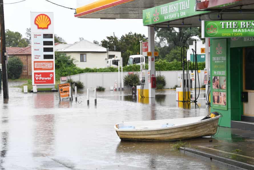 The same petrol station, but with cars unable to drive on flooded roads, locals used a boat instead