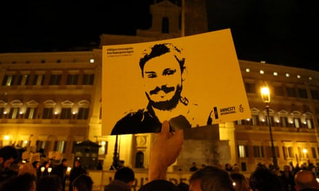 placard bearing likeness of Giulio Regeni at an outdoor commemoration in Rome