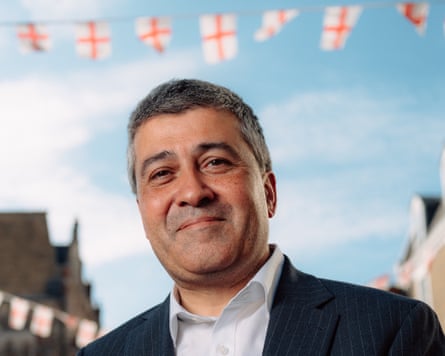 Portrait of Katwala in front of a string of England flags