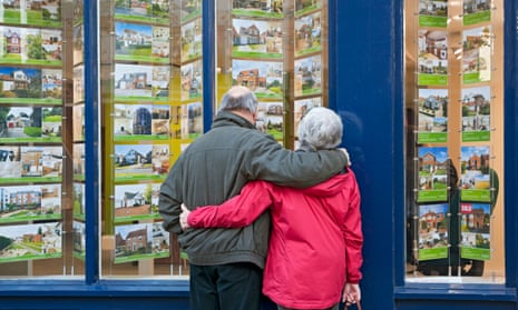 Older couple looking in estate agent's window York, North Yorkshire.