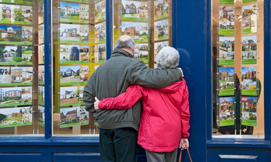 Older couple looking in estate agent’s window