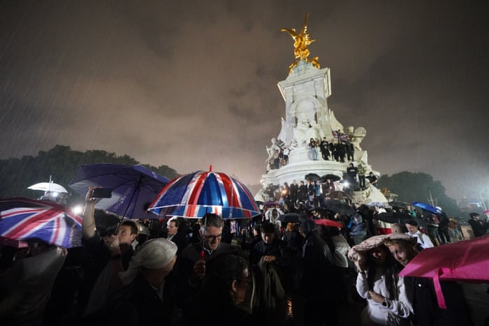 Mourners on Queen Victoria Memorial outside Buckingham Palace on Thursday night.
