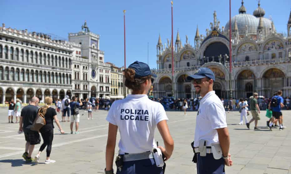 Police keep a watchful eye in St Mark’s Square. 