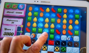 A person plays on his tablet with Candy Crush Saga games developed by British King Digital Entertainment