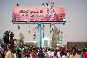 Demonstrators climb billboards during the protest