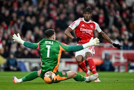 Noni Madueke slots the ball past Sam Tickle to score Arsenal's first goal.