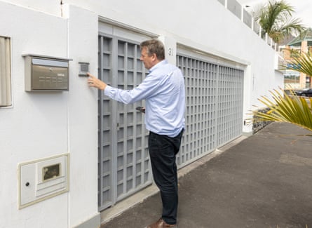 Dan Boffey presses the doorbell of a property