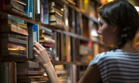 woman looking at books in a library