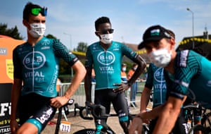 Kevin Reza and his team mates show their support for the Black Lives Matter movement before the start today.