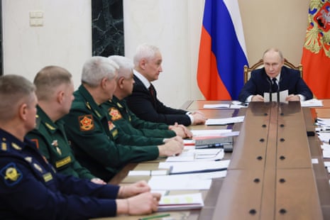 Vladimir Putin attends a meeting with senior military officers at the Kremlin in Moscow.