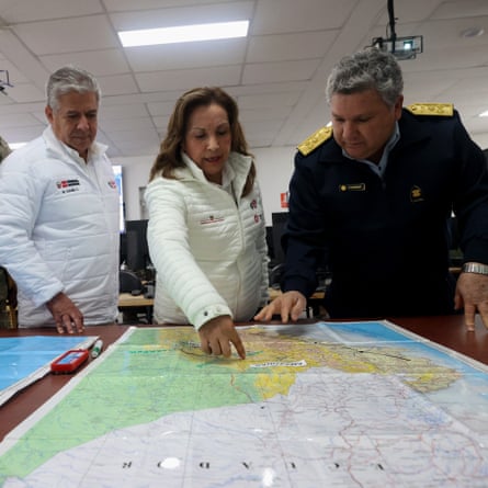 The Peruvian President Dina Boluarte and the defense minister Walter Astudillo watching a map during a meeting to supervise the deployment of helicopters and aircraft to combat the wildfires in the San Martin Region.